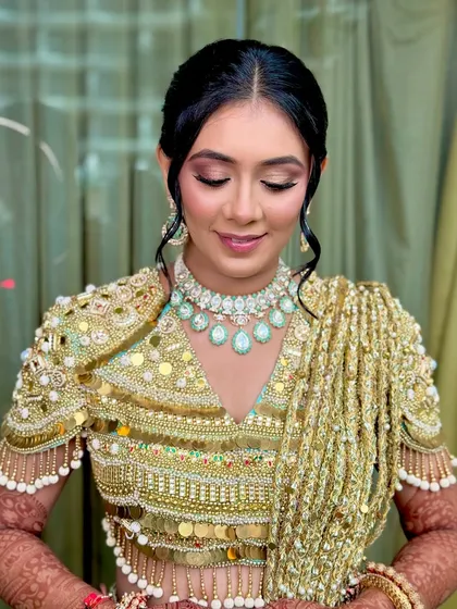 A close-up of the Haldi makeup, featuring a soft pink and gold eyeshadow look and a flawless base.