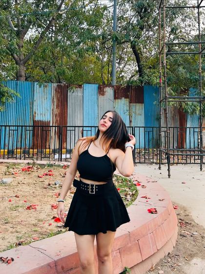 A candid, hair-flip moment in the black dress. This adds energy and movement to the photo.