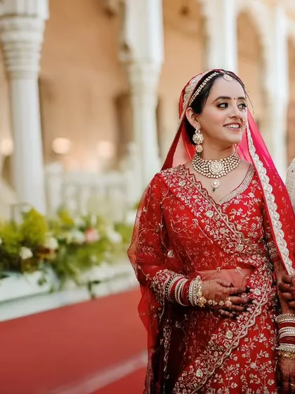 A candid shot of the couple sharing a quiet look during their wedding day portraits against the backdrop of elegant palace architecture.