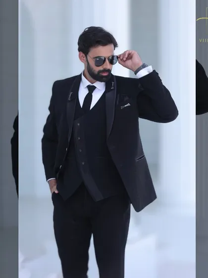 A different angle of our timeless black three-piece suit. We ensure every custom suit is perfectly fitted to your measurements for a comfortable and stylish experience.