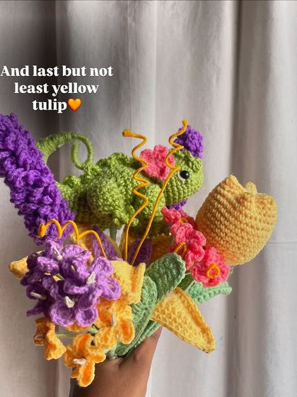 The final flower, a yellow tulip, is added to the Rapunzel bouquet before wrapping.