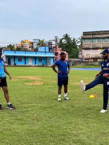 Demonstrating a dynamic warm-up drill on the field. It's vital that athletes understand the purpose of each movement, so I often perform the drills with them to coach the finer points of technique and intent.