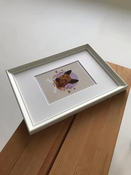 The framed Chiku portrait resting on a wooden surface. This simple, elegant presentation makes it a perfect keepsake.