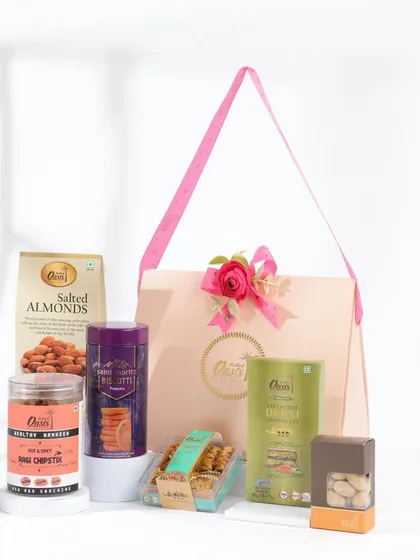 A simple yet elegant Rakhi gift hamper. This option includes a variety of our savory snacks, cookies, and salted almonds, perfect for a sibling who prefers savory over sweet.