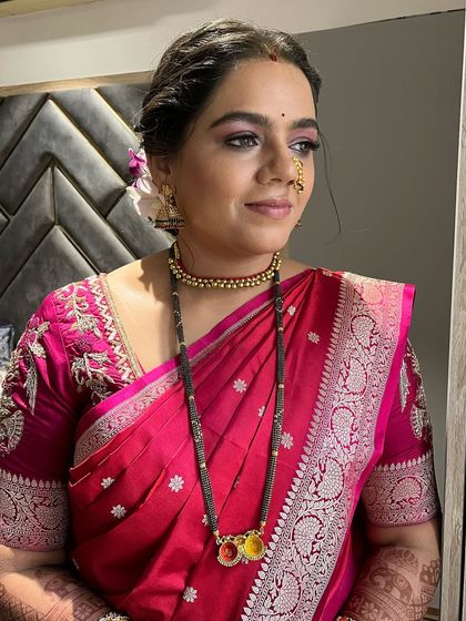 The complete look, showing the beautiful pink saree and traditional mangalsutra. The makeup is subtle, enhancing her features naturally.