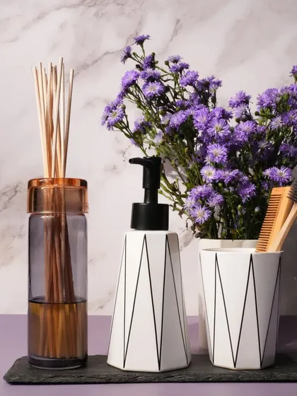 Our reed diffusers are perfect for keeping bathrooms and washrooms smelling fresh for up to three months. This image showcases one in a modern bathroom setting, adding both fragrance and a touch of decor.