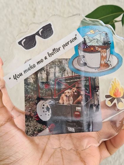 This personalized resin coaster captures a perfect memory. It includes a photo of beloved pets, a meaningful quote, and stickers that represent a love for the outdoors.