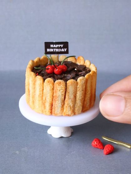 A miniature chocolate birthday cake, a perfect gift for a loved one.