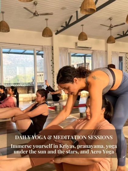 Daily yoga and meditation sessions are a cornerstone of my retreats. Here, I'm assisting a student in boat pose, helping her find core strength and stability.