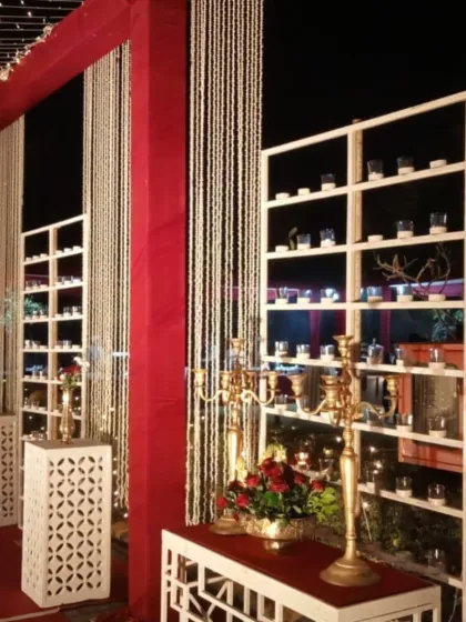 A beautiful decor element featuring shelves with candles and floral arrangements, adding warmth and light to the venue.