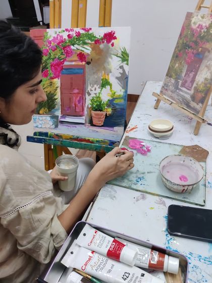 This series captures an adult student working on two different acrylic paintings, one a floral doorway and the other an abstract piece, showing the variety of styles we teach.