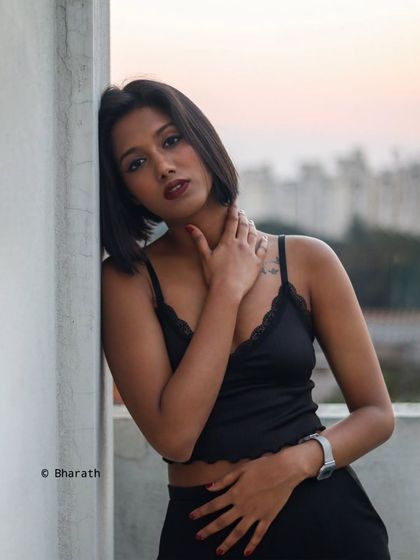 This portrait captures a thoughtful expression against the soft, warm tones of the sunset, creating a peaceful and beautiful image.