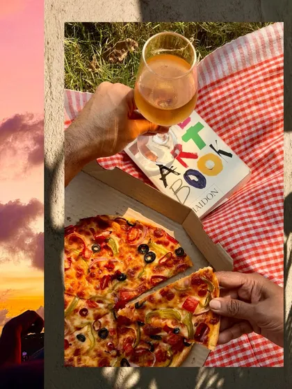 A golden hour picnic, with pizza and wine glowing in the late afternoon sun.