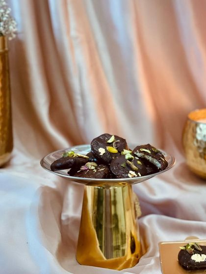 My Flaky Chocolate Bites are rich, buttery, handcrafted cookies dipped in luxurious dark chocolate and cocoa butter. They are a sophisticated addition to any festive hamper.