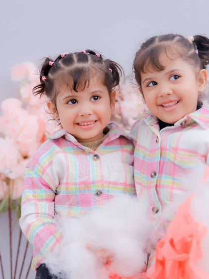 Twin smiles that light up the room. We love capturing the special connection that twins share during our kids photoshoots.