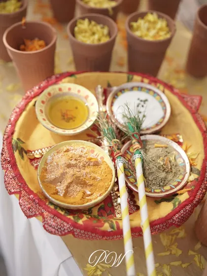 The traditional Haldi platter, with bowls of turmeric paste and other sacred ingredients, beautifully arranged for the ceremony.