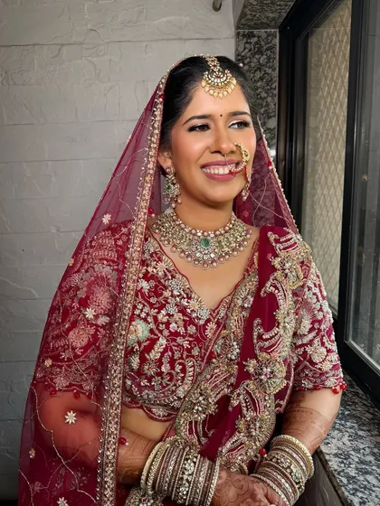 The pure joy on a bride's face. Her hair is styled in a classic updo, keeping the focus on her radiant smile and stunning bridal jewelry for her wedding day.