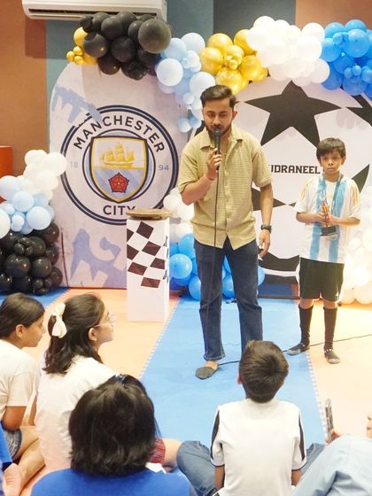 The birthday boy takes the mic, sharing a moment in the spotlight during his Manchester-themed celebration.