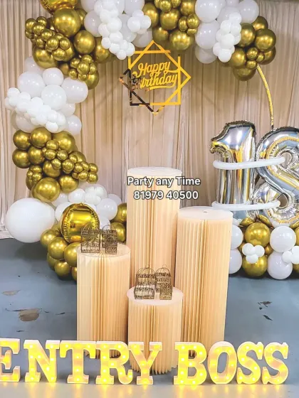 Another take on an 18th birthday, this one with a white and gold balloon arch and fun "Entry Boss" light-up letters.