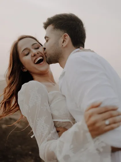 Pre-wedding shoots are for capturing your real dynamic. This playful, candid moment on the beach, full of laughter and movement, shows the couple's genuine connection before the big day.