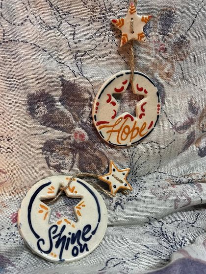 The 'Hope' and 'Shine On' ornaments together. They make a wonderful gift set for a loved one.
