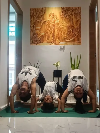 Family yoga time at home. Here we are practicing Chakrasana, or the wheel pose, together. It's amazing to see my son's natural flexibility and enthusiasm for yoga.