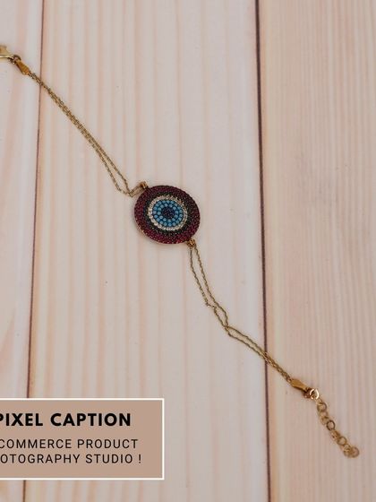 A top-down flat-lay of the evil eye bracelet on a wooden background.