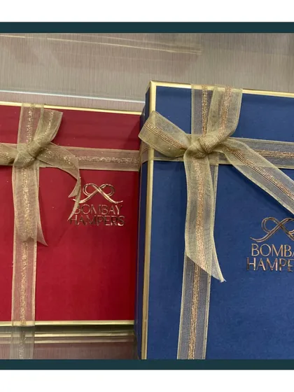 My signature gift boxes are a statement of quality and elegance. The gold foil logo on the rich red and blue boxes ensures your gift looks premium from the very first glance.