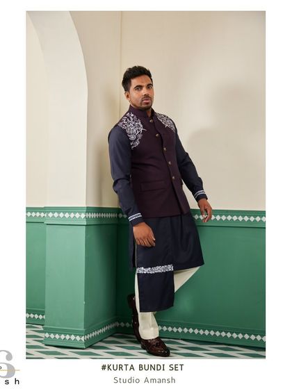 This angled view of the space blue bundi set highlights the detailed silver handwork on the shoulder and cuff, adding a touch of modern artistry to a traditional outfit.