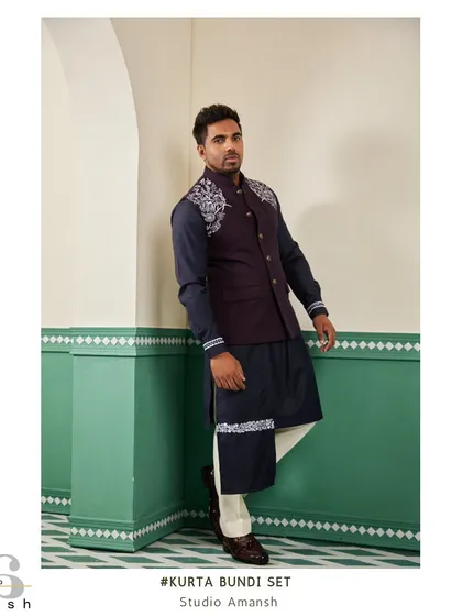 This angled view of the space blue bundi set highlights the detailed silver handwork on the shoulder and cuff, adding a touch of modern artistry to a traditional outfit.
