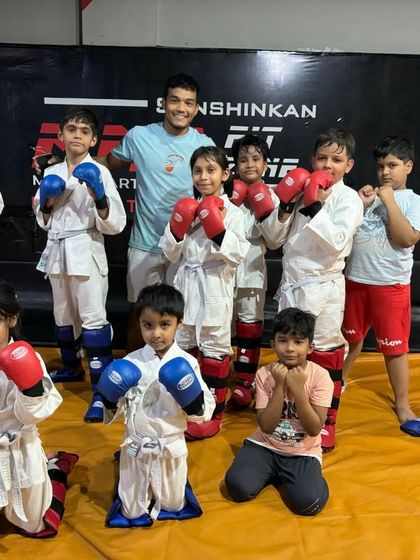 Ready for action. A group of my young students geared up in their boxing gloves, ready to practice their striking techniques in a safe and structured class.