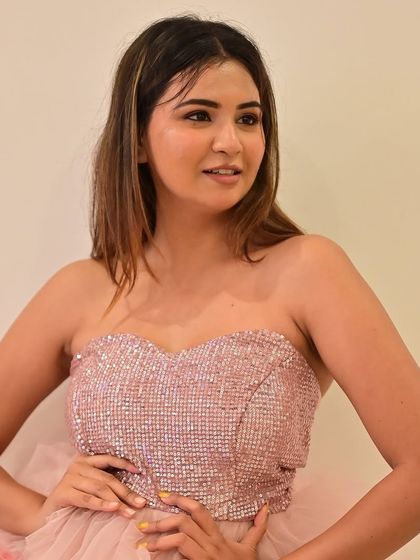 A model in a fun, tiered pink party dress.