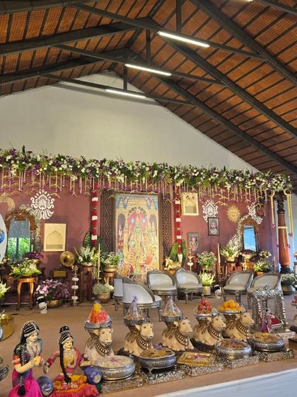 An angled shot of the naming ceremony decor, showing a fun 'Guess My Name' sign and the silver cradle to the side.