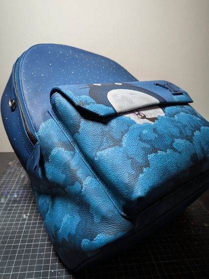 The art isn't just on the front. I made sure the dreamy cloudscape wraps around the entire base and pockets of the backpack for a complete look from any angle.