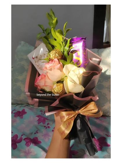 A special bouquet I created for Women's Day. It includes fresh roses, chocolates, and other small treats, designed to pamper the special women in your life.