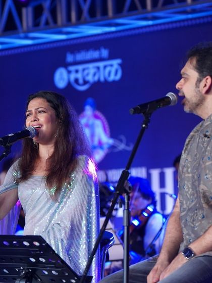 Another angle of the performance, showing the full band and stage setup.