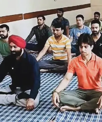 A group of students at the ARI Maritime College practicing a seated spinal twist. These outreach programs are an important part of our mission to make yoga accessible to everyone.