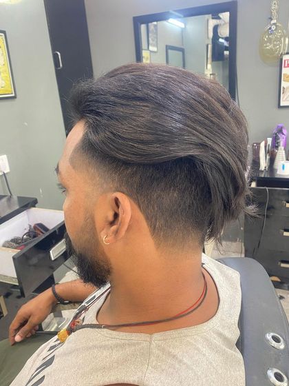 A side view of the undercut, demonstrating how the long hair on top can be swept back for a dramatic effect.