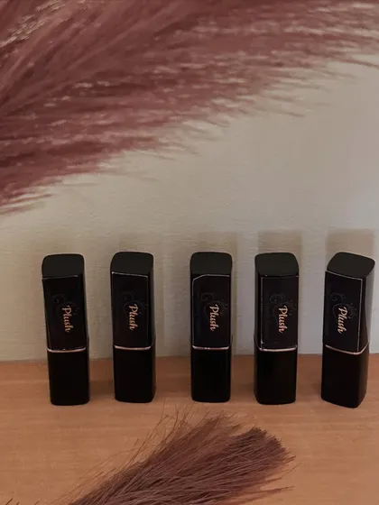 A lineup of my five lipstick shades in their sleek black packaging. I'm excited to expand the shade range if the response continues to be positive.