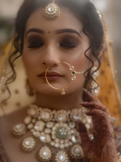 A beautiful close-up of the bride with her eyes closed. This serene and peaceful moment captures her inner calm and beauty on her wedding day.