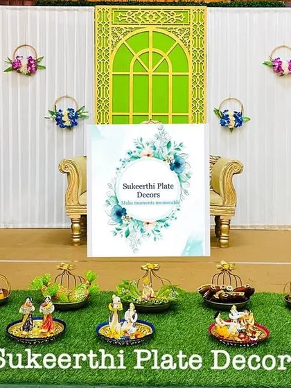 For this engagement at Natraj Mahal, I created a setup with hanging basket props and thematic dolls. The 'uppu kudai' (salt basket) is a traditional element I often include.