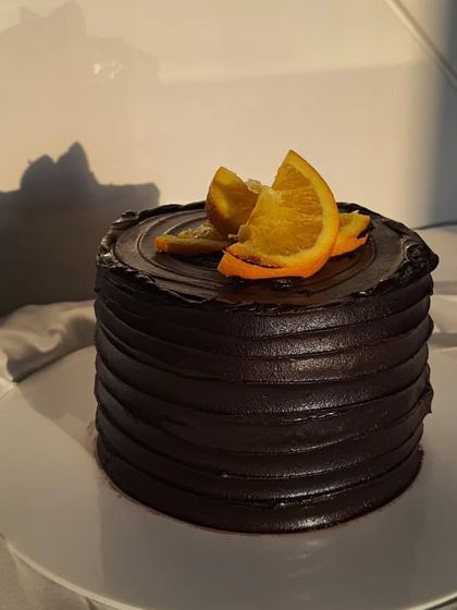 My Mandarin Chocolate cake is an absolute beauty. The dark, rich chocolate frosting is complemented by the bright, fresh orange slices on top.