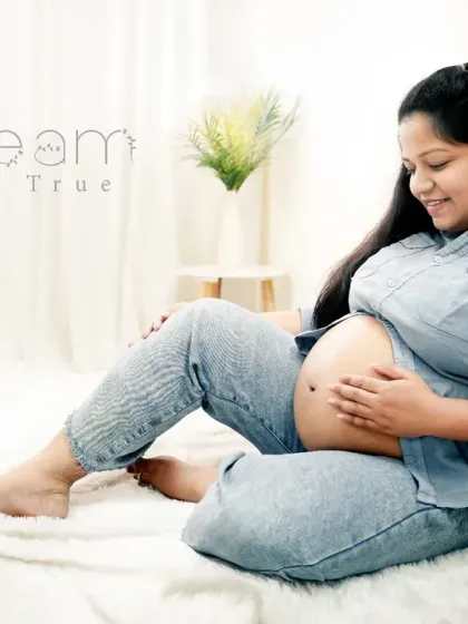 A dream come true. This relaxed, floor-seated pose captures a moment of pure joy and connection as the mom-to-be lovingly gazes at her baby bump during her lifestyle maternity shoot.