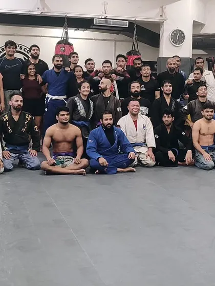 A proud moment for our coaching team after a belt promotion ceremony. This picture captures the strong bond and mutual respect within our tight-knit community.