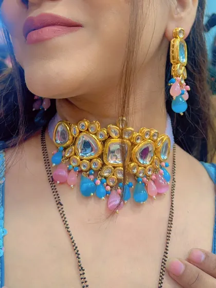 A close-up of a different jewellery option: a modern Kundan choker with pink and blue beads.