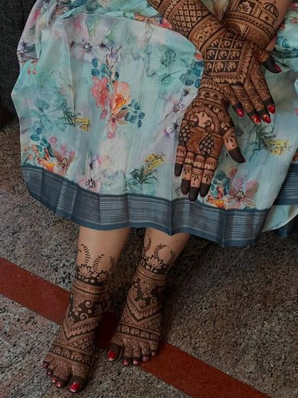 Another angle of the full bridal look, highlighting the beautiful coordination between the hand and foot mehendi.