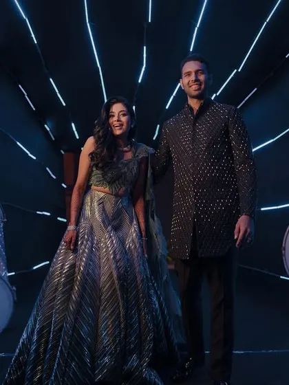 This couple's Sangeet entry was all about the bling and the beat. Flanked by dhol players, they made an electrifying entrance, ready to kick off a night of non-stop dancing.