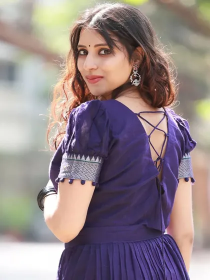 This shot highlights the interesting design of the blouse, with its crisscross tie-up back. It's a great example of how we capture unique design details in our collabs.