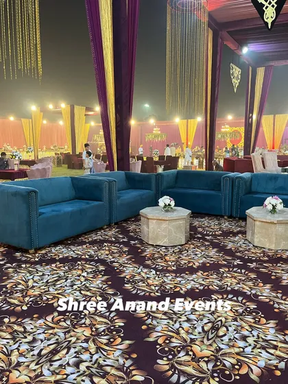 Plush teal sofas and hexagonal coffee tables create a modern and stylish lounge area for guests to relax and socialize.