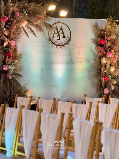 The stage viewed from behind the guest chairs, highlighting the elegant seating arrangement.